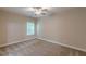 Bedroom with plush carpet, neutral walls, and a modern ceiling fan at 150 Whitworth Dr, Locust Grove, GA 30248