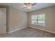 Cozy bedroom featuring neutral walls, plush carpeting, and a ceiling fan for added comfort at 150 Whitworth Dr, Locust Grove, GA 30248