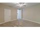Neutral bedroom with plush carpeting, white trim, and a door leading to other rooms at 150 Whitworth Dr, Locust Grove, GA 30248