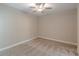 A spacious carpeted bedroom features recessed lights, neutral paint and trim, and a ceiling fan at 150 Whitworth Dr, Locust Grove, GA 30248