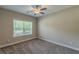 Bedroom featuring plush carpet, natural light, and neutral colored walls at 150 Whitworth Dr, Locust Grove, GA 30248
