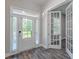 Open-concept entry way featuring luxury vinyl floors, large windows, and glass panel French doors at 150 Whitworth Dr, Locust Grove, GA 30248