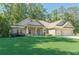 Beautiful single story brick home with an attached two car garage and a luscious green lawn at 150 Whitworth Dr, Locust Grove, GA 30248