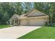 Charming single story brick home featuring an attached two car garage and a long driveway at 150 Whitworth Dr, Locust Grove, GA 30248