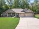 Beautiful single story brick home featuring an attached two car garage and well-maintained landscaping at 150 Whitworth Dr, Locust Grove, GA 30248