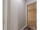 Hallway with hardwood flooring leading into a carpeted bedroom at 150 Whitworth Dr, Locust Grove, GA 30248