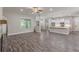 Open-concept living area with fireplace, modern flooring, and direct kitchen access at 150 Whitworth Dr, Locust Grove, GA 30248