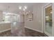 Open-concept living room with hardwood floors, modern lighting, and ample space for entertaining at 150 Whitworth Dr, Locust Grove, GA 30248