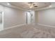 Large main bedroom with tray ceilings, recessed lighting and ensuite bathroom access at 150 Whitworth Dr, Locust Grove, GA 30248