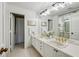 Bathroom with double sinks, a vanity, and a walk-in shower beyond the doorway at 2660 Peachtree Nw Rd # 23A, Atlanta, GA 30305
