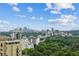 A stunning skyline view of the city surrounded by green trees and blue skies at 2660 Peachtree Nw Rd # 23A, Atlanta, GA 30305