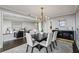 Formal dining room with modern chandelier open to the living room at 2660 Peachtree Nw Rd # 23A, Atlanta, GA 30305
