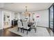 Formal dining room with modern chandelier and wet bar at 2660 Peachtree Nw Rd # 23A, Atlanta, GA 30305