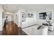 Hallway with built-in shelving unit, leading to the main living area, featuring recessed lighting and modern decor at 2660 Peachtree Nw Rd # 23A, Atlanta, GA 30305