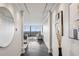 Long hallway with white walls, hardwood floors, recessed lighting, and a view into the living room with cityscape view at 2660 Peachtree Nw Rd # 23A, Atlanta, GA 30305