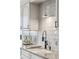 Detailed shot of a modern kitchen featuring granite countertops, subway tile, and sleek, dark hardware accents at 2660 Peachtree Nw Rd # 23A, Atlanta, GA 30305