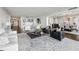 Spacious living room showcasing an open floor plan, dining area, modern decor, and hardwood floors at 2660 Peachtree Nw Rd # 23A, Atlanta, GA 30305