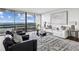 Bright living room featuring large windows, a balcony, and a comfortable seating area with modern decor at 2660 Peachtree Nw Rd # 23A, Atlanta, GA 30305