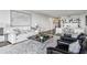 Open-concept living area featuring comfortable seating, built-in shelving, and hardwood floors with ample natural light at 2660 Peachtree Nw Rd # 23A, Atlanta, GA 30305