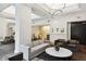Bright lounge featuring modern furniture, artwork, and a partial view of the dining area at 2660 Peachtree Nw Rd # 23A, Atlanta, GA 30305