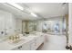Bright main bathroom with double sinks, a jacuzzi, and a standing shower at 2660 Peachtree Nw Rd # 23A, Atlanta, GA 30305