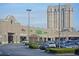 Shopping center with various stores, including Publix, surrounded by a parking lot, hedges, and a high-rise building at 2660 Peachtree Nw Rd # 23A, Atlanta, GA 30305