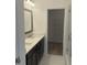 Modern bathroom with double sinks, quartz counters, framed mirror, and walk-in shower at 358 Olmstead Way # 25, Alpharetta, GA 30022