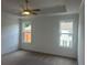Spacious bedroom with a ceiling fan, carpet, and two bright windows at 358 Olmstead Way # 25, Alpharetta, GA 30022