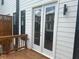 View of the sliding doors leading out to the wooden deck with exterior lighting at 358 Olmstead Way # 25, Alpharetta, GA 30022
