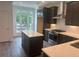 Bright kitchen with stainless steel appliances, quartz countertops, island, and a view of the yard at 358 Olmstead Way # 25, Alpharetta, GA 30022