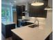 Stylish kitchen with dark cabinets, quartz countertops, island, and stainless steel appliances at 358 Olmstead Way # 25, Alpharetta, GA 30022