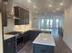 Modern kitchen featuring stainless steel appliances, a central island, and an open layout at 358 Olmstead Way # 25, Alpharetta, GA 30022