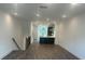 Bright living room with hardwood floors leading to a kitchen island and window view at 358 Olmstead Way # 25, Alpharetta, GA 30022