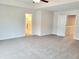 Spacious bedroom with ceiling fan, gray carpet, ensuite, and doorways to other rooms at 4849 Walkers Green, Mableton, GA 30126