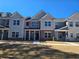 Charming townhome with brick accents, covered front porch, and manicured lawn at 4849 Walkers Green, Mableton, GA 30126