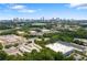 Scenic aerial view showcasing the city skyline, a lake, and industrial buildings enveloped by lush greenery at 1244 Chelsea Nw Cir, Atlanta, GA 30318