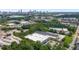 Expansive aerial view featuring industrial buildings amidst green spaces and a distant city skyline at 1244 Chelsea Nw Cir, Atlanta, GA 30318