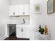 Elegant bar area with cabinets, a sink, a beverage refrigerator, and bar accessories at 1244 Chelsea Nw Cir, Atlanta, GA 30318