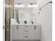 Modern bathroom featuring a double vanity with black fixtures, frameless shower, and ample lighting for functionality at 1244 Chelsea Nw Cir, Atlanta, GA 30318
