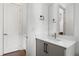 A modern bathroom features light gray cabinets, a white countertop, and sleek fixtures, including a frameless mirror at 1244 Chelsea Nw Cir, Atlanta, GA 30318