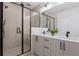 Sleek bathroom boasts double vanity, black fixtures, frameless shower, and minimalist cabinets, seamlessly blending style and function at 1244 Chelsea Nw Cir, Atlanta, GA 30318
