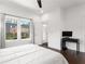Bedroom with bed, TV on a black table, and natural light streaming through the window at 1244 Chelsea Nw Cir, Atlanta, GA 30318