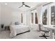 Bright bedroom with neutral carpet and white walls features a workstation and three large windows at 1244 Chelsea Nw Cir, Atlanta, GA 30318