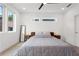 Inviting bedroom featuring a cozy bed, contemporary decor, and plenty of natural light from adjacent windows at 1244 Chelsea Nw Cir, Atlanta, GA 30318