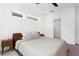 Bright bedroom with streamlined windows, carpet floors, neutral bedding, and modern minimalist bedside furniture at 1244 Chelsea Nw Cir, Atlanta, GA 30318