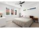 Spacious bedroom with ample natural light, modern ceiling fan, neutral carpet, and stylish contemporary furnishings at 1244 Chelsea Nw Cir, Atlanta, GA 30318