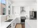 Bright kitchen featuring stainless appliances, white cabinets, lots of light and quartz counters at 1244 Chelsea Nw Cir, Atlanta, GA 30318