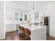 Stylish kitchen boasts white cabinets, stainless steel appliances, and a central island with seating at 1244 Chelsea Nw Cir, Atlanta, GA 30318