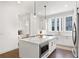 Well-lit kitchen with white cabinets, stainless steel appliances, and an island with built-in microwave at 1244 Chelsea Nw Cir, Atlanta, GA 30318