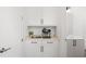 A well-lit kitchenette features white cabinets, countertops, and a modern coffee maker with stainless steel accents at 1244 Chelsea Nw Cir, Atlanta, GA 30318